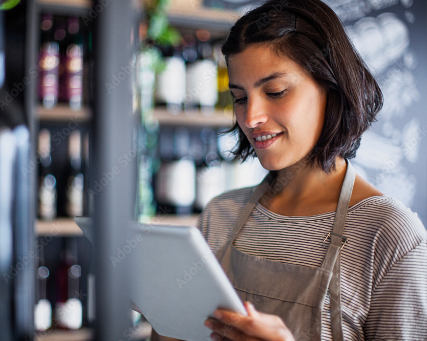 woman viewing vendor information on ipad | liquor store pos